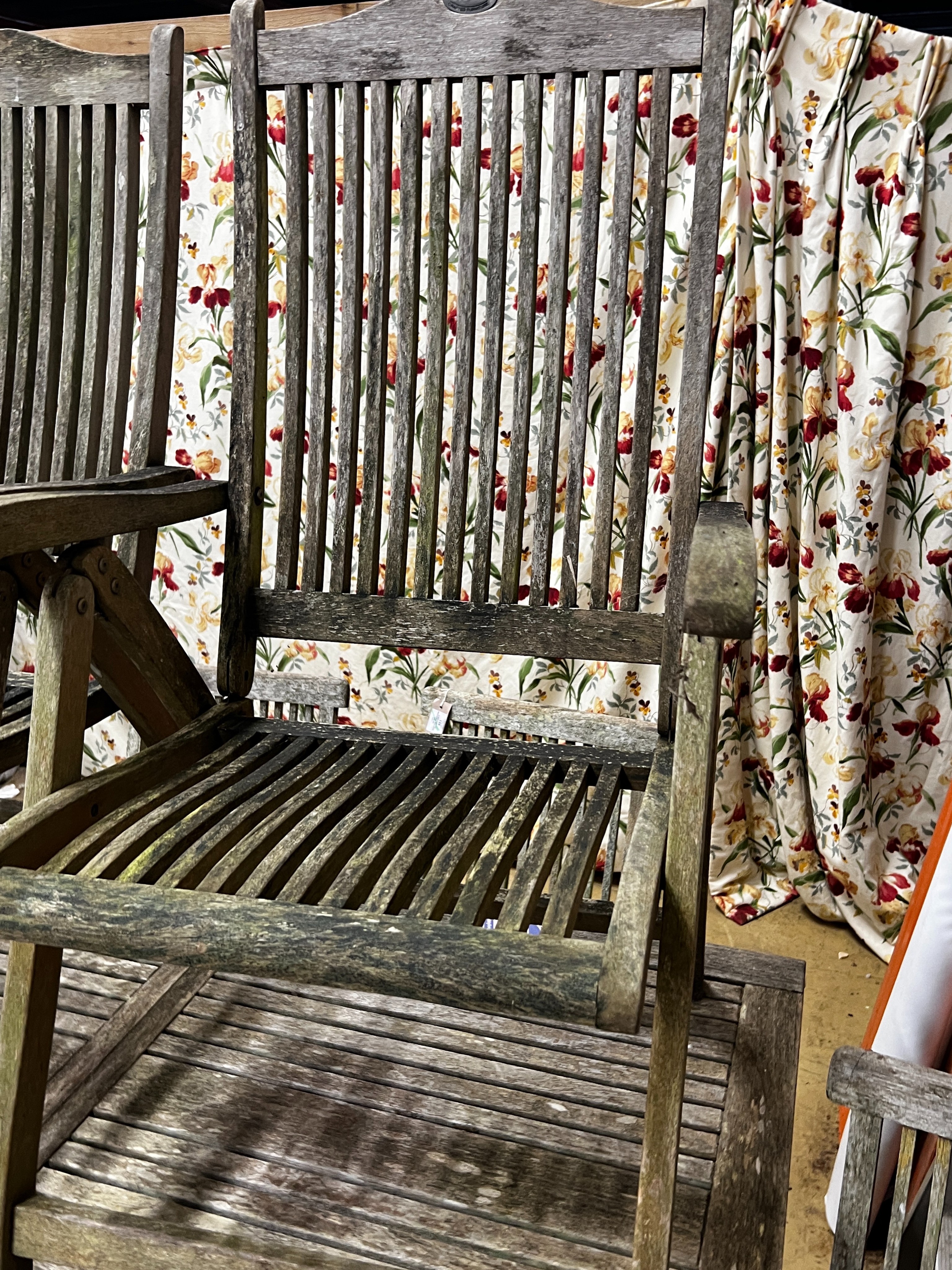 A rectangular weathered teak extending garden table, length 192cm extended, width 89cm, height 76cm together with eight teak folding garden chairs, two with arms